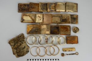 Sixteen cigarette cases and ten bracelets, a wire purse, a comb, a chain, and a powder compact. Credit: The Museum of Eastern Bohemia